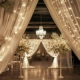 Best party hall in Islamabad featuring elegant round tables with white chairs, grand chandeliers, high ceilings, and a beautifully decorated interior set for a formal event.