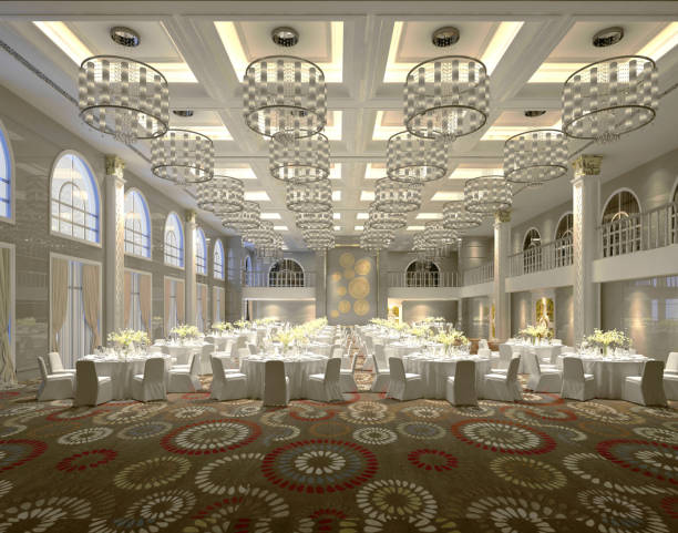 best party hall in islamabad with round dining tables, white chairs, grand chandeliers, high ceiling, and decorative carpet — set up for a formal event or wedding reception